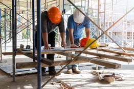 Engineer discussing with foreman about project in building construction site