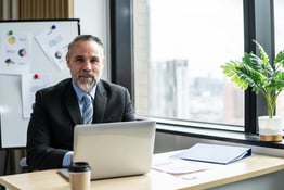 Portrait of Caucasian senior businessman working in office workplace.