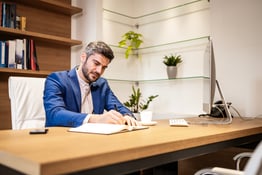 Experienced financial director working in his office and making calculations