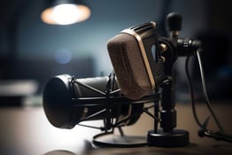 Two microphones are shown on a desk.