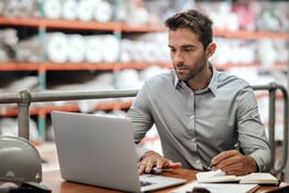 man using laptop, working on business administration efficiency