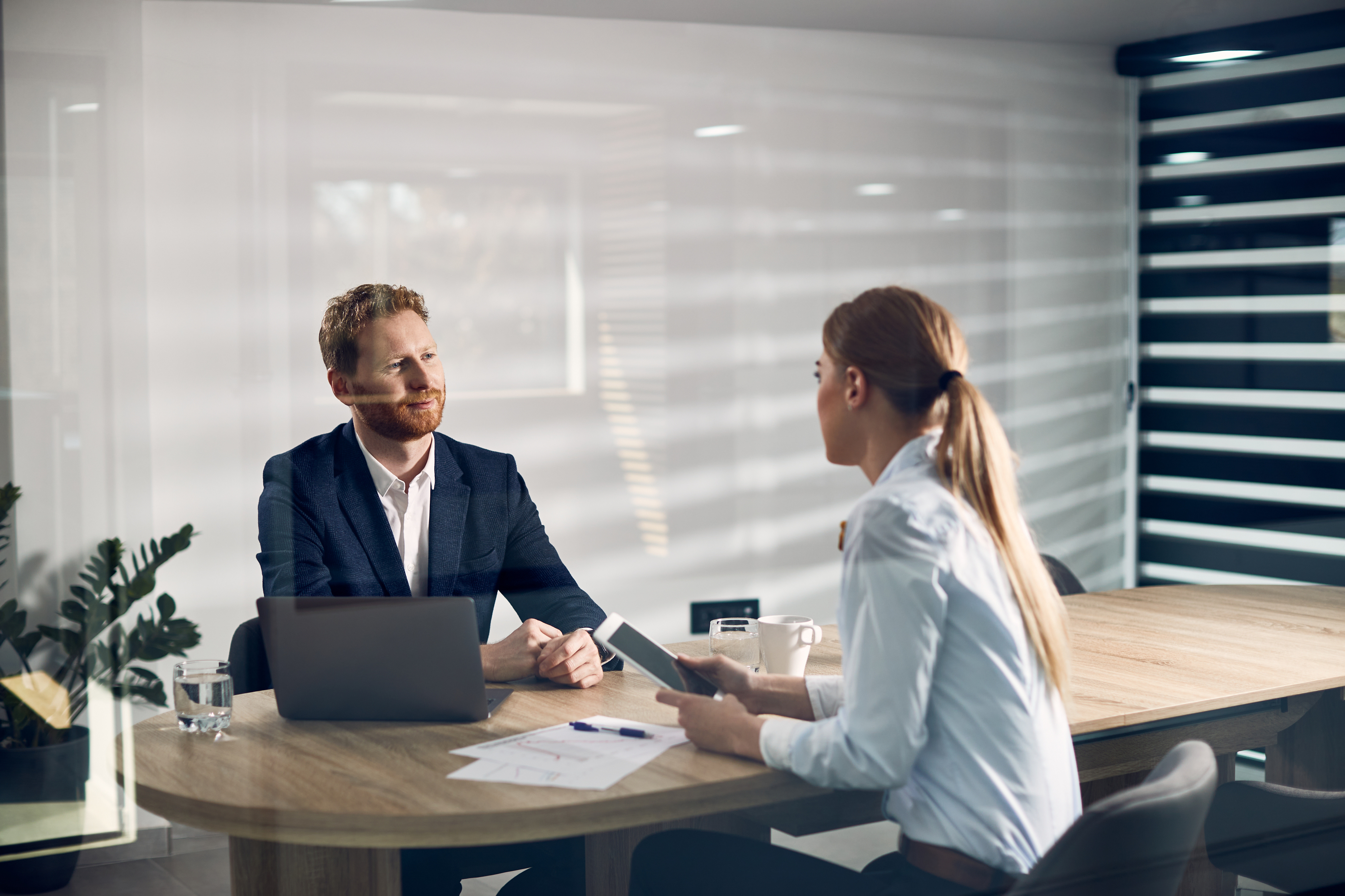 Two business people sitting across from each other at a meeting